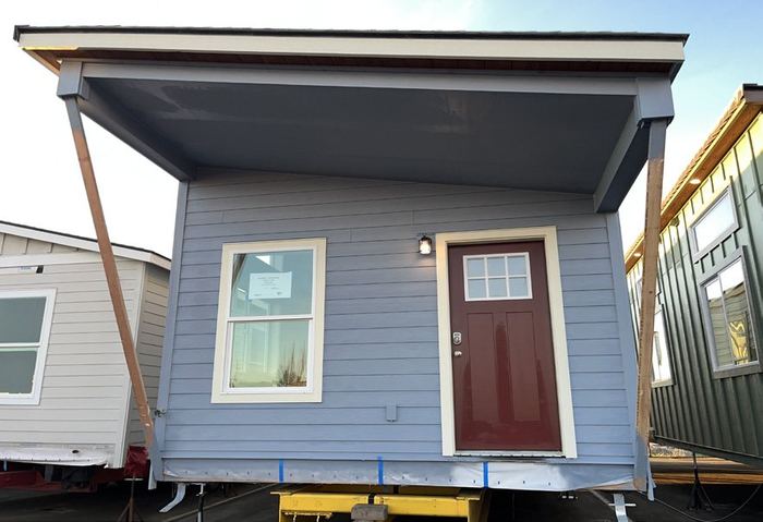 Open shed-roof extension over a porch