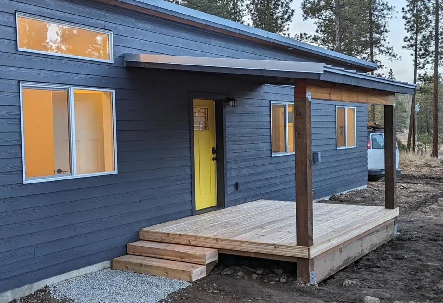 Shed-roof covered porch on a blue Wolf home