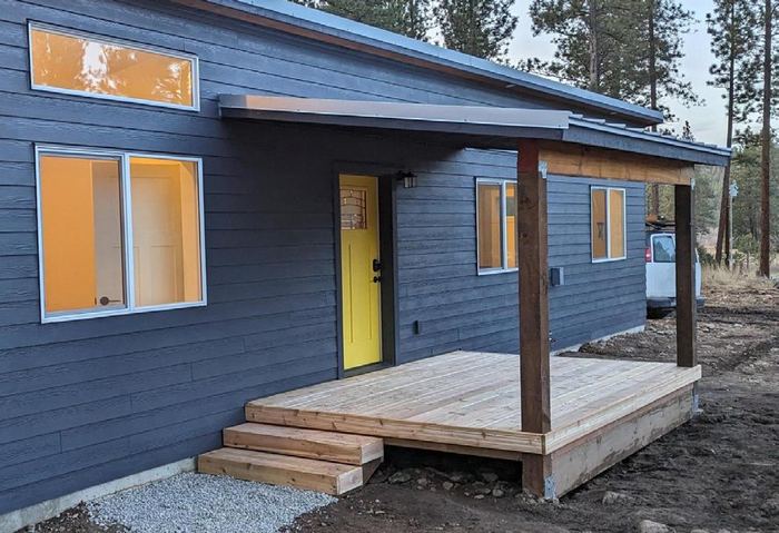 Shed-roof covered porch on a blue Wolf home