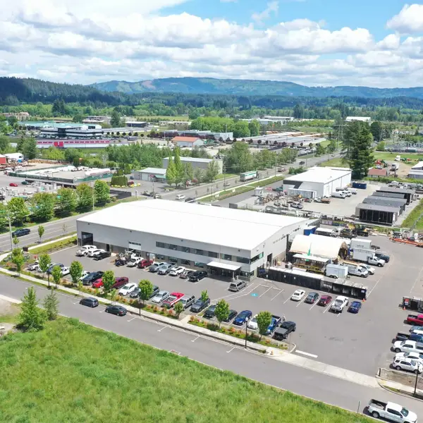 Aerial of the Wolf factory with forested hills behind it