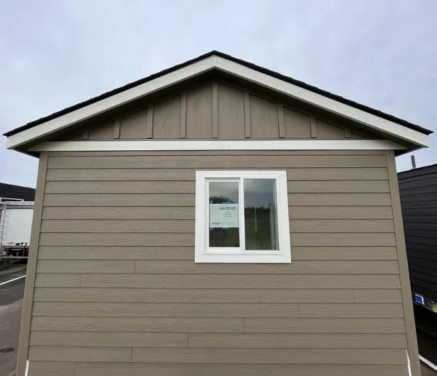 Board-and-batten gable on a tan Wolf home