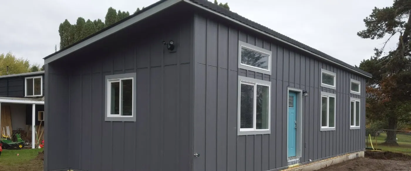 Model E with dark board-and-batten siding