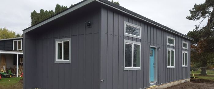 Model E with dark board-and-batten siding