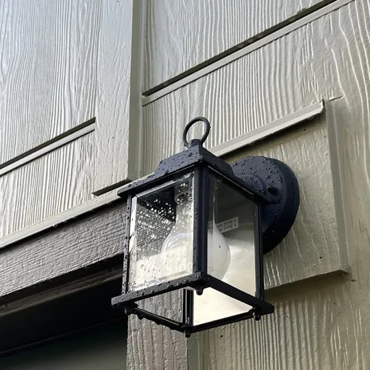 Black carriage light on lap siding