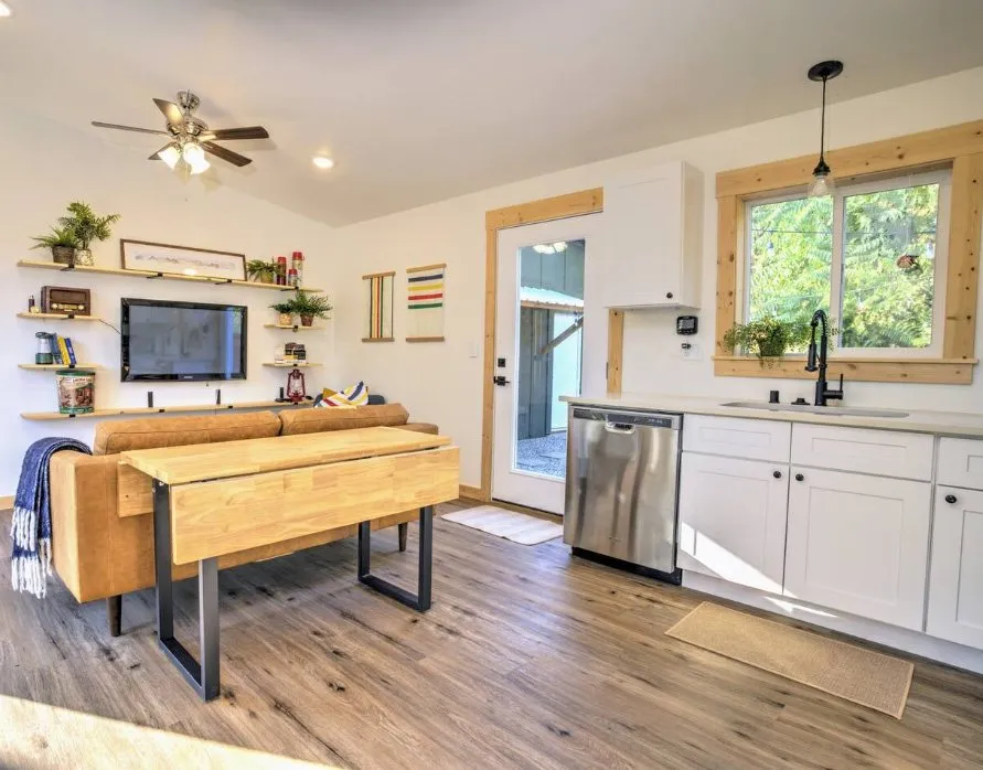 Wolf home interior with a live-edge table, white Shaker kitchen, and LVP floors