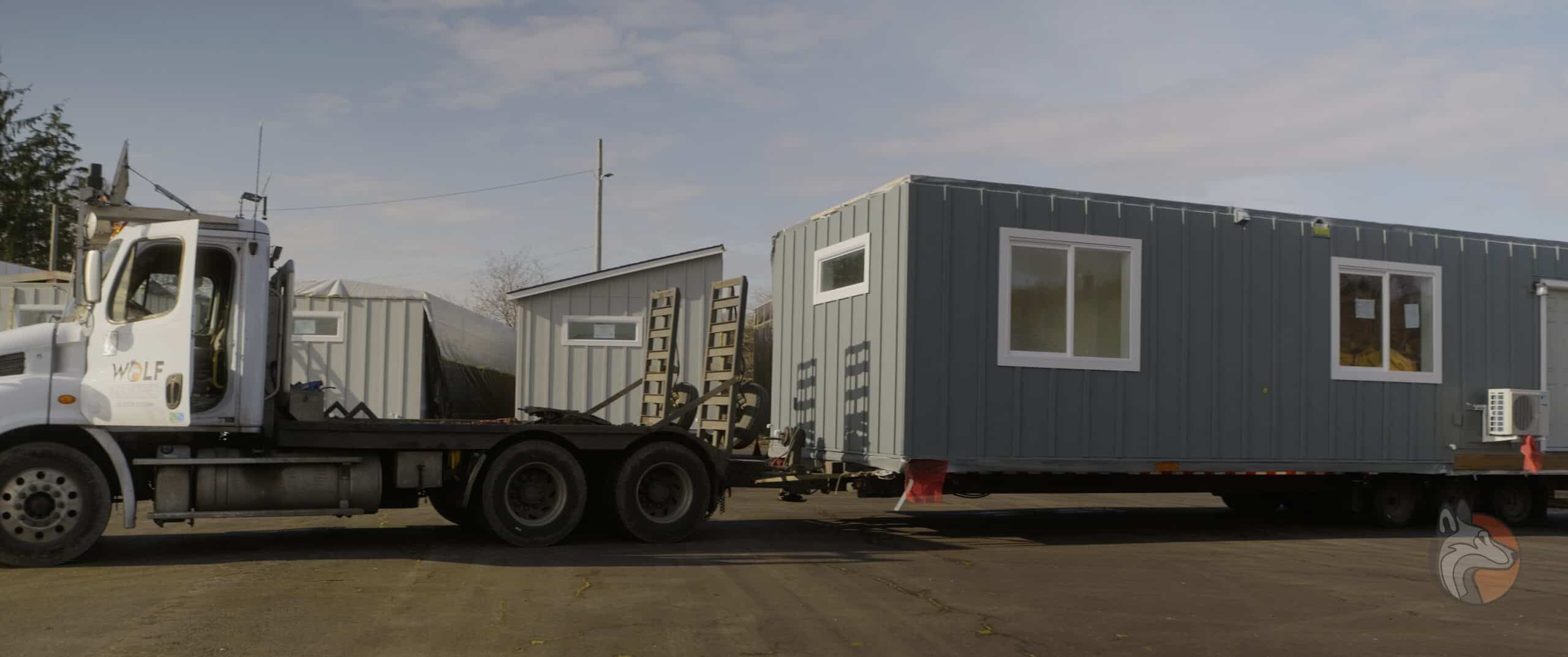 A finished Wolf modular home being transported to its site