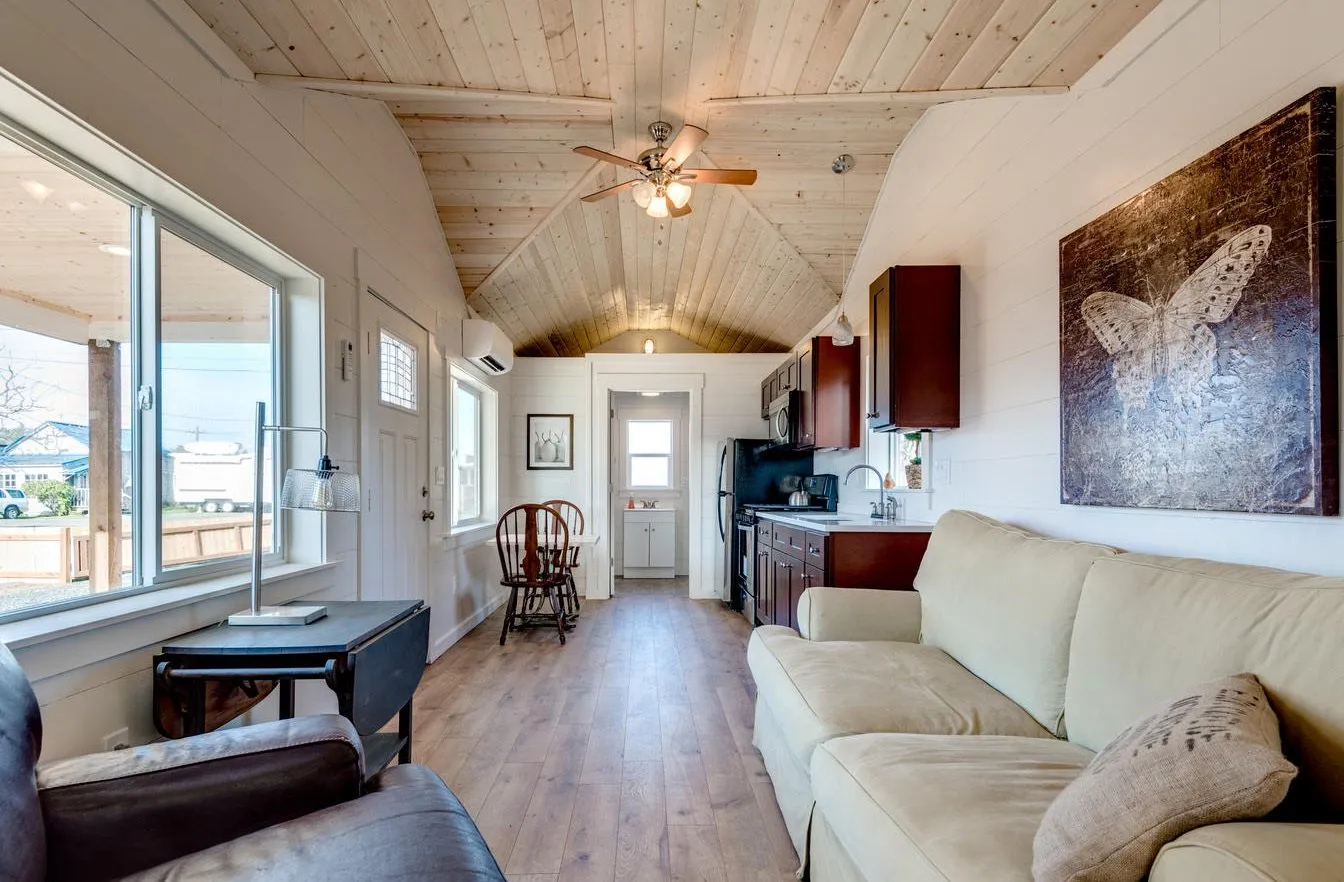 Living room with a pine tongue-and-groove ceiling, shiplap walls, and LVP floors
