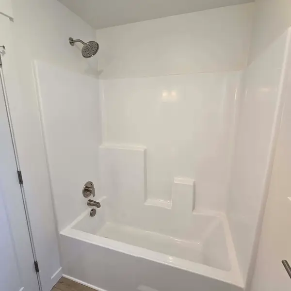 White one-piece tub and shower in a Wolf Model B bathroom