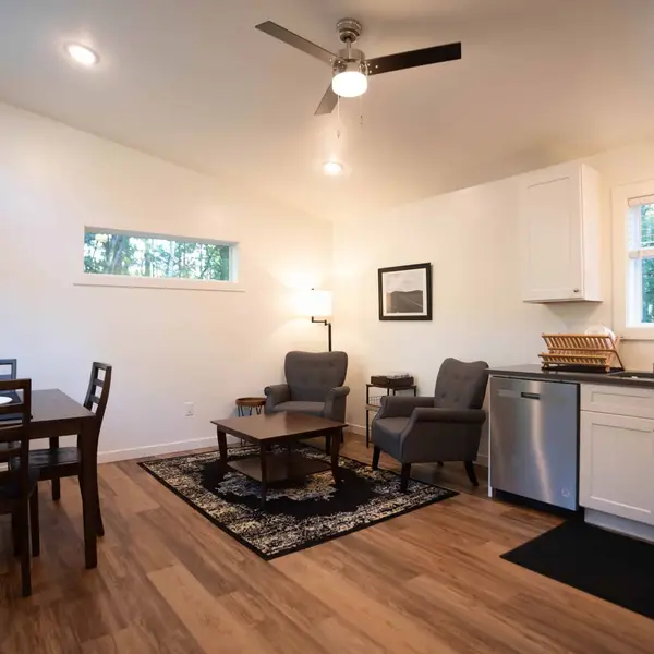 Dining table and kitchen sink in one open room in a Wolf Model F