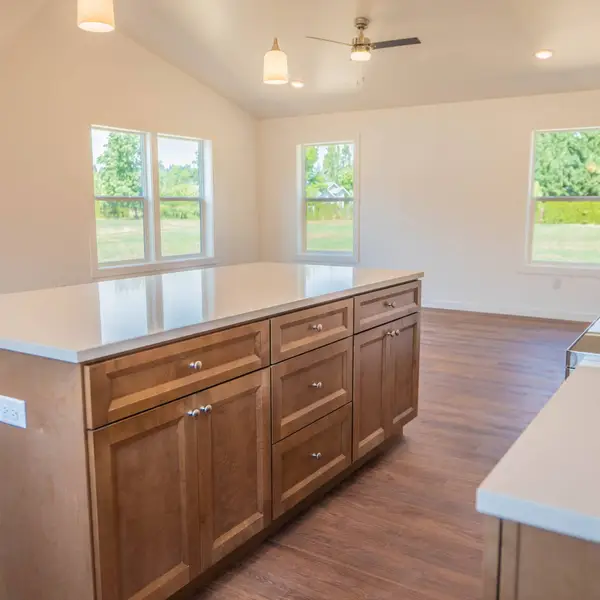 Kitchen island with honey wood cabinets in an open Wolf Model I