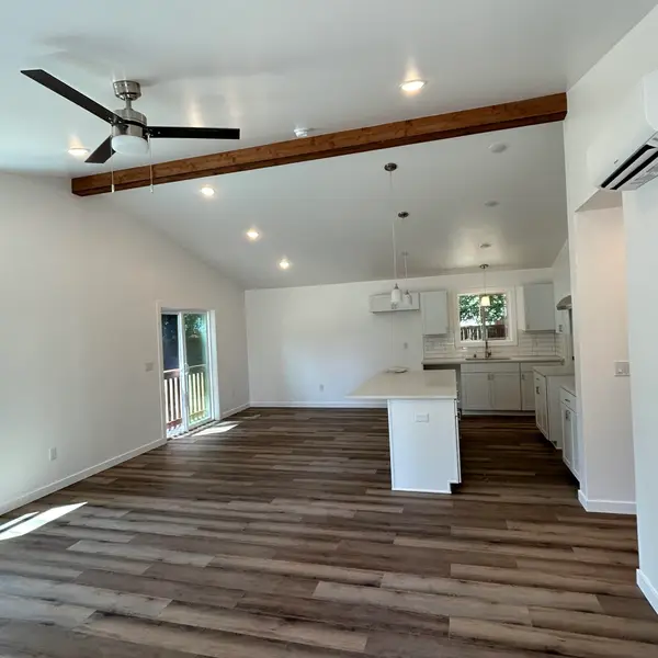 Open living room looking toward a white kitchen island in a Wolf Model I