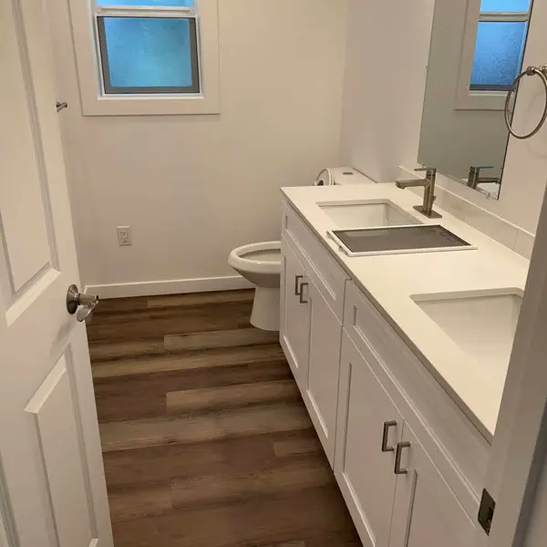 Narrow bathroom with a long white double vanity in a Wolf Model I