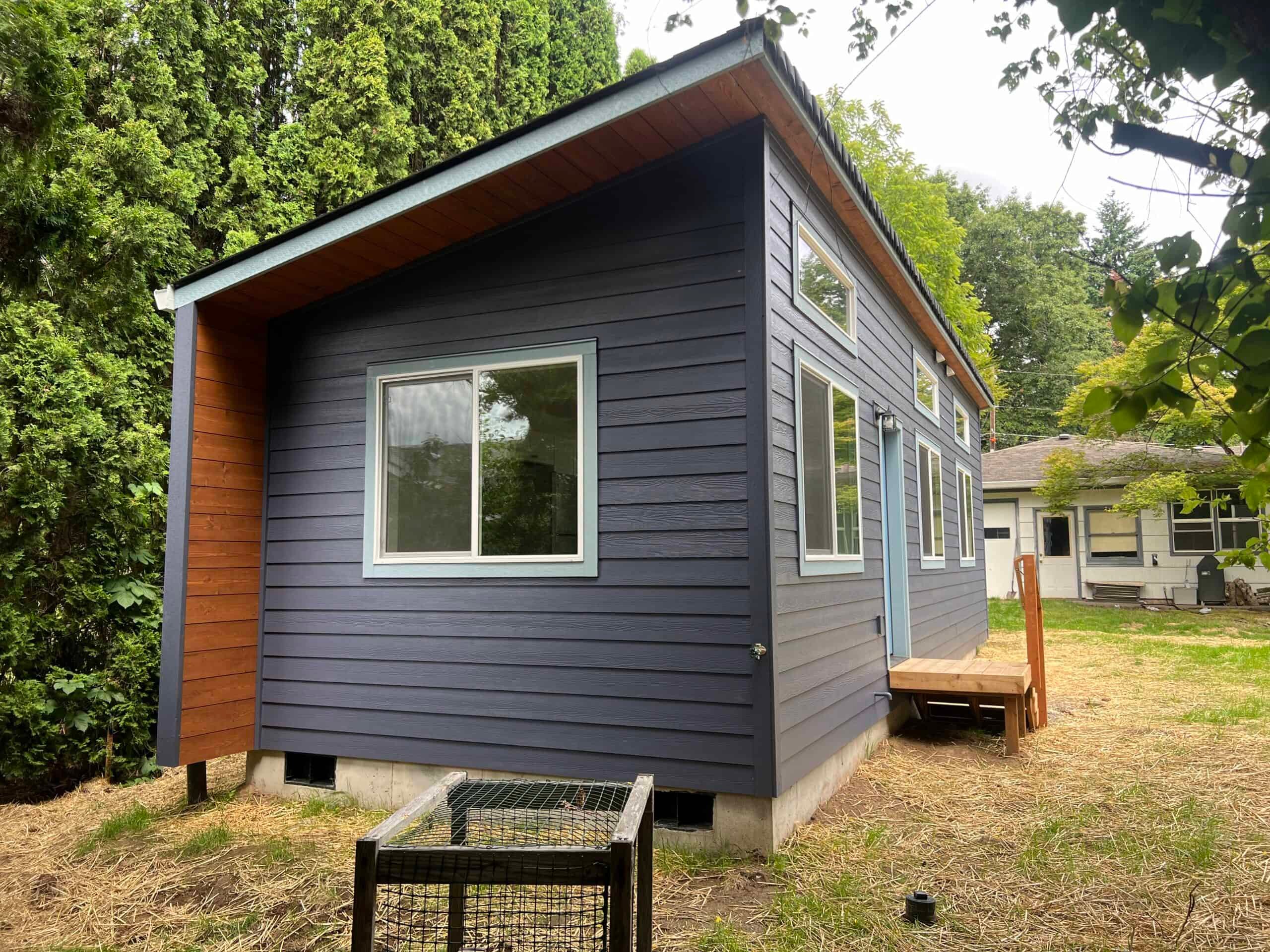 Wolf modular cottage with dark siding and wood trim in Portland, Oregon