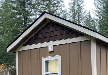 Gable-roof Wolf home with cedar-shake gable and white trim