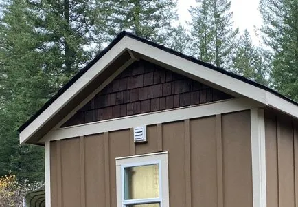 Gable-roof Wolf home with cedar-shake gable and white trim