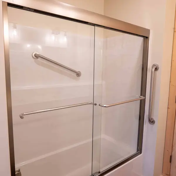 Tub-shower with sliding glass doors and stainless grab bars
