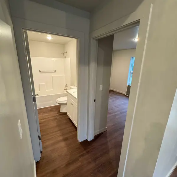 Hallway looking into a bathroom and an empty bedroom in a Wolf Model L