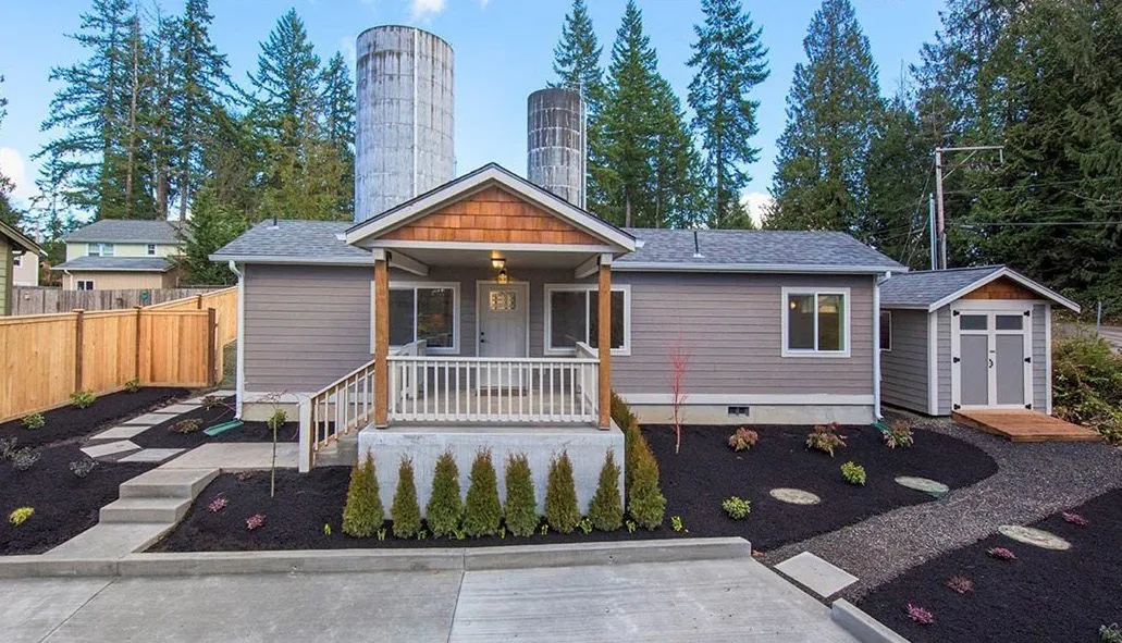 Gray Wolf home with a covered porch and white railings