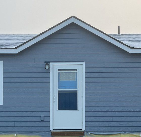 Blue lap siding carried up into the gable