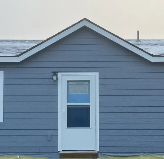 Blue lap siding carried up into the gable
