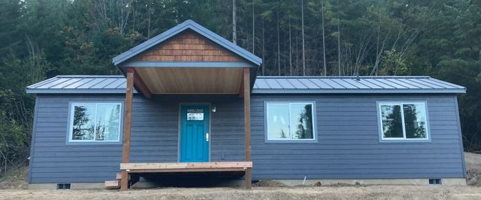 Model E with blue lap siding and a metal roof