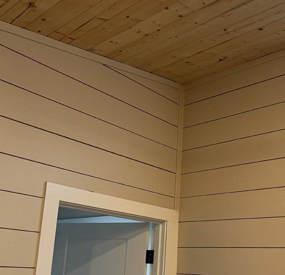 Pine tongue-and-groove ceiling over shiplap walls