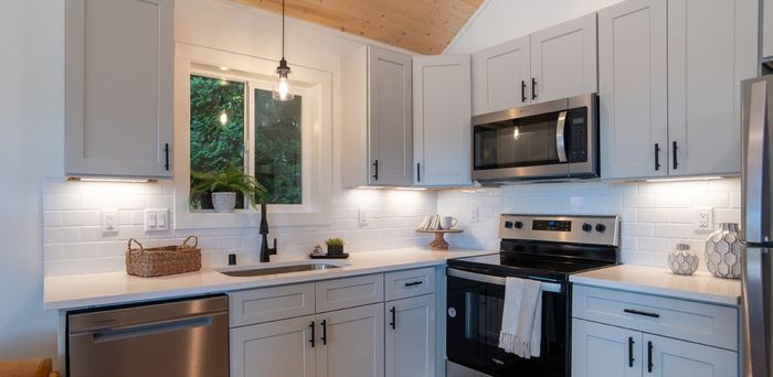 Light-gray kitchen with tall upper cabinets
