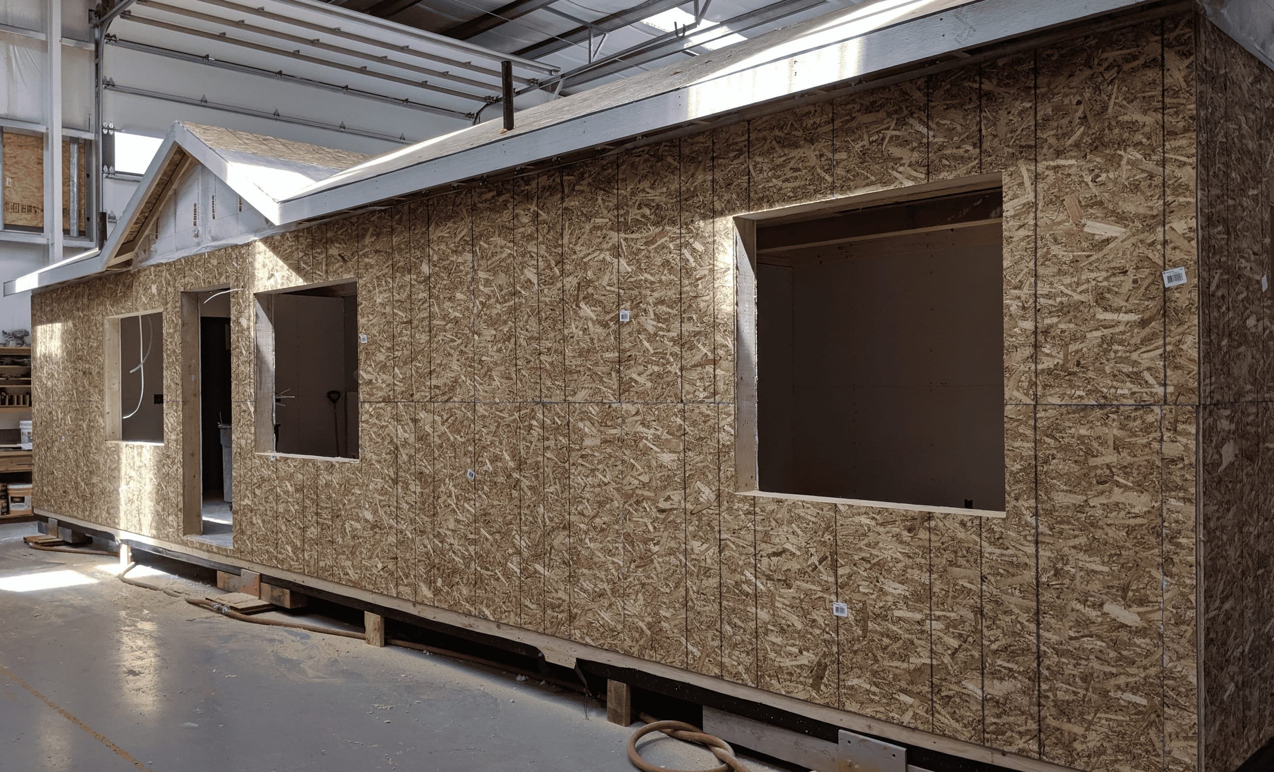 A Wolf home with framed walls and window openings under construction inside the Battle Ground factory.
