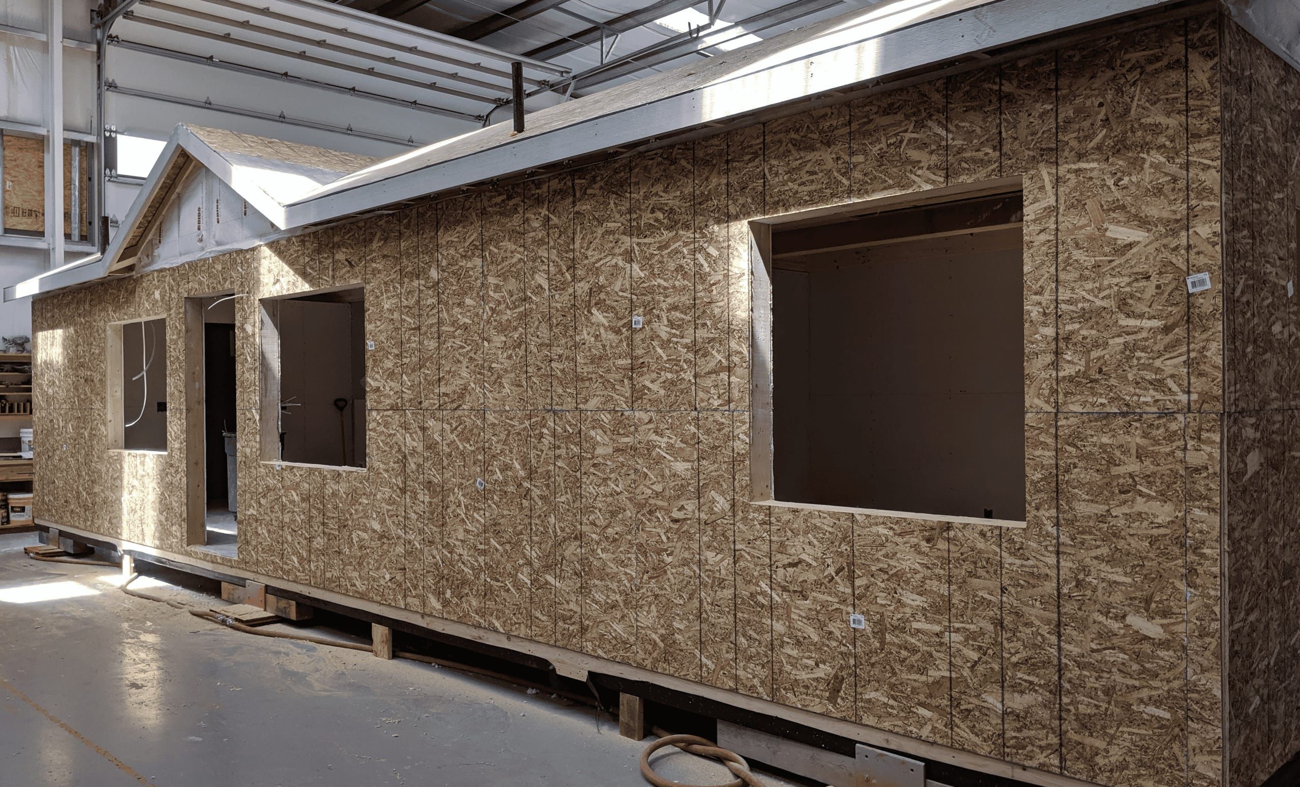A Wolf home with framed walls and window openings under construction inside the Battle Ground factory.