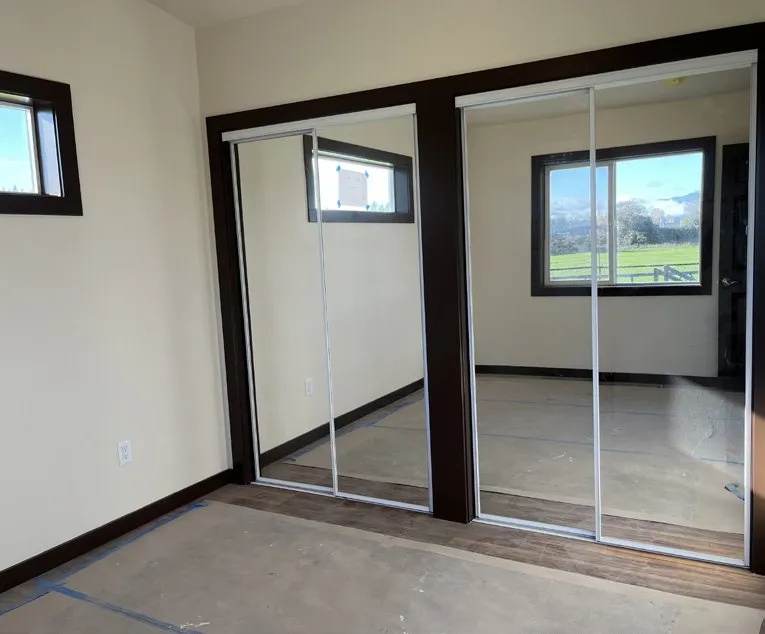 Dark-trimmed closet doors against light walls