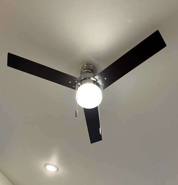White ceiling with a black ceiling fan