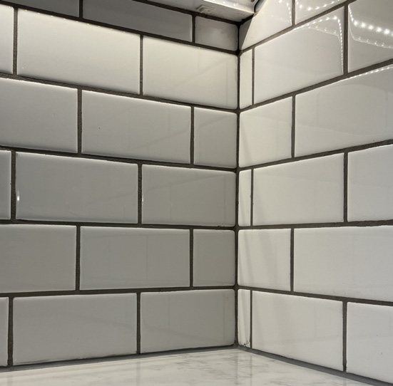 Full-height white subway tile