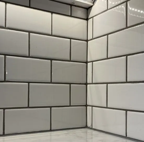 Full-height white subway tile