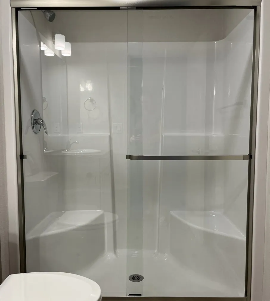 Walk-in shower with a glass sliding door