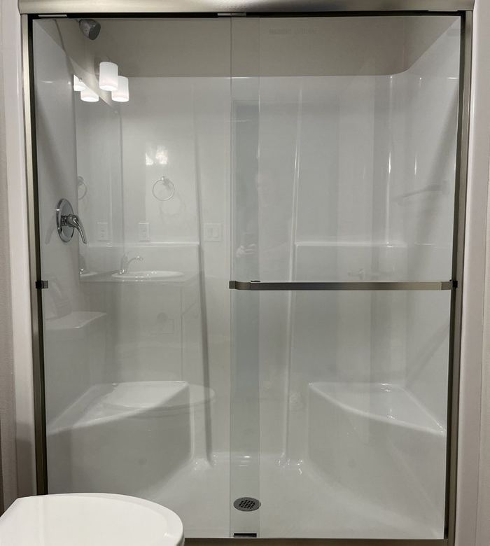 Walk-in shower with a glass sliding door