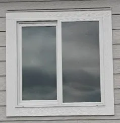 White vinyl window in gray siding