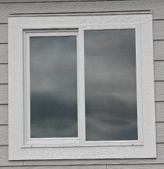 White vinyl window in gray siding