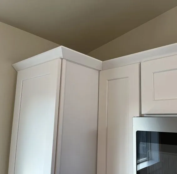 White upper cabinets with crown molding