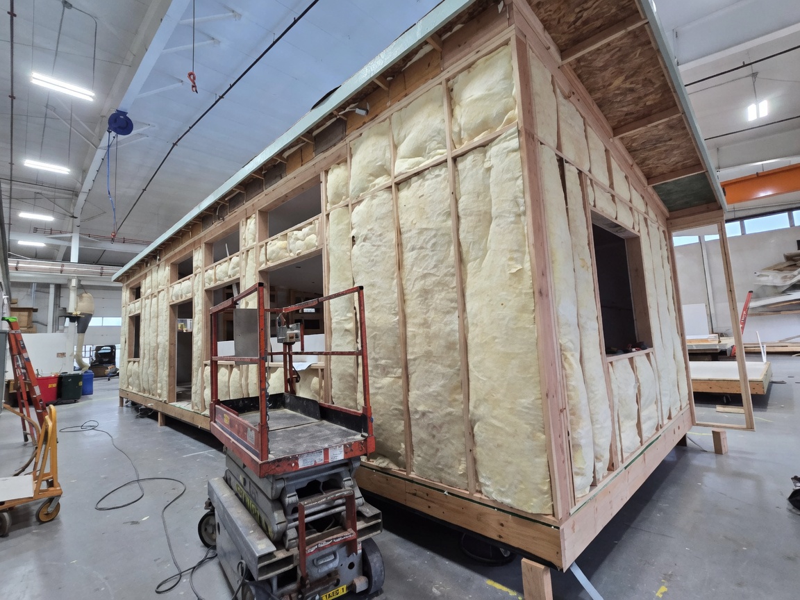 Spray-foam insulated Wolf Model E module framed inside the factory.