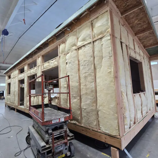 Spray-foam insulated Wolf Model E module framed inside the factory.