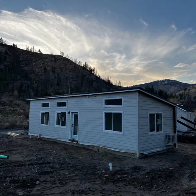 Grey and white Wolf Model E home with transom windows.