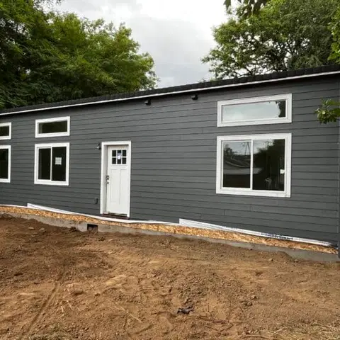 Gray and white Wolf Model E home with transom windows.