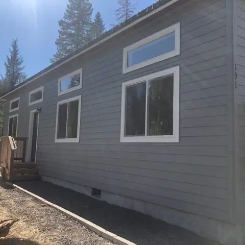 Grey and white Wolf Model E home with transom windows.