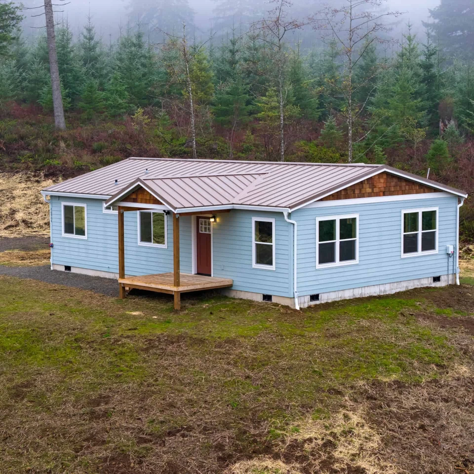Wolf Model I home with metal gable roof and cedar shakes.