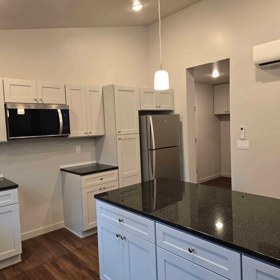Kitchen island and refrigerator in a Wolf Model L home.