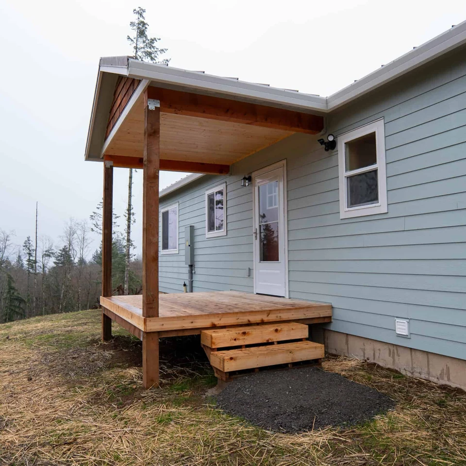 Covered porch with deck on a Wolf Model I home.