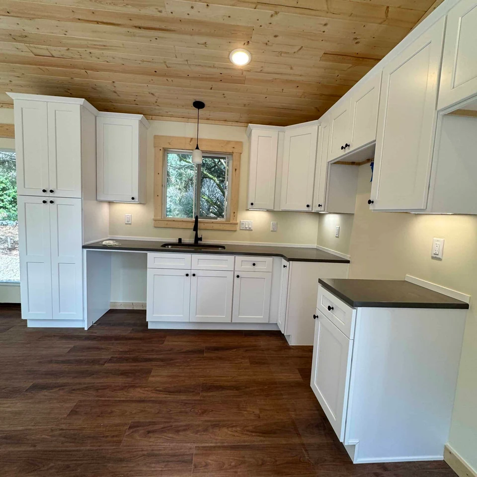 Kitchen with detailed trim and undermount sink in a Wolf Model F home.