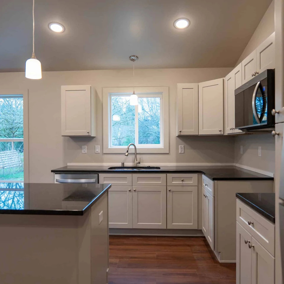 View into kitchen from mud room in a Wolf Model L home.