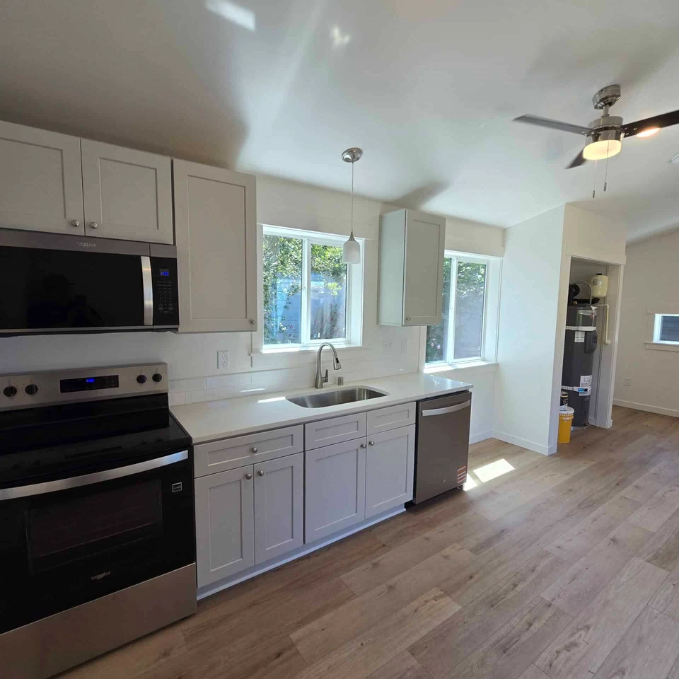 Single Wall Kitchen with Undermount Sink and Tile Backsplash in a Wolf Model B home.