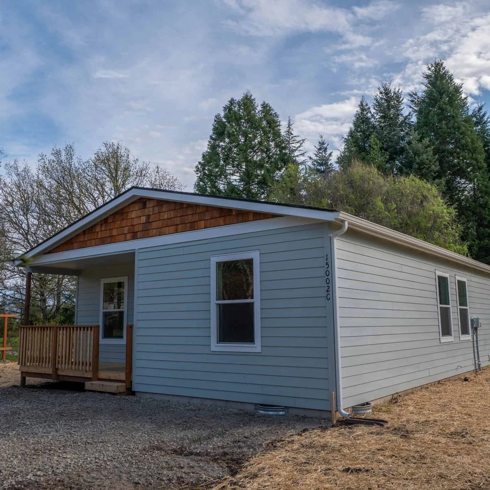 Wolf Model L home with built-in covered porch with deck.